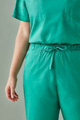 Unisex reversible scrub pants in Surgical Green, featuring pockets on both sides, designed for healthcare professionals.