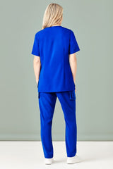 Women's Electric Blue scrub pants in XXS, featuring a slim leg, multiple pockets, and moisture-wicking fabric for comfort.