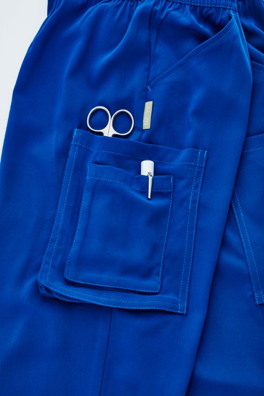 Electric Blue slim leg scrub pants for women with multiple pockets, designed for comfort and utility in healthcare settings.