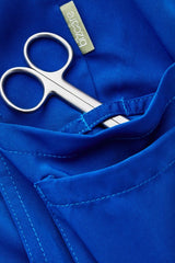 Electric Blue slim leg scrub pants featuring multiple pockets and a tapered fit, perfect for healthcare professionals.