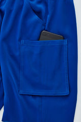 Electric Blue women's scrub pants in XXS with tapered legs and multiple cargo pockets for healthcare professionals.