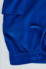 Electric blue women's scrub pants with tapered leg, multiple pockets, and moisture-wicking fabric, size XXS.