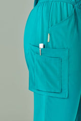 Teal women's scrub pants with straight leg design, multi pockets, and roll-up features for healthcare professionals. Size S.