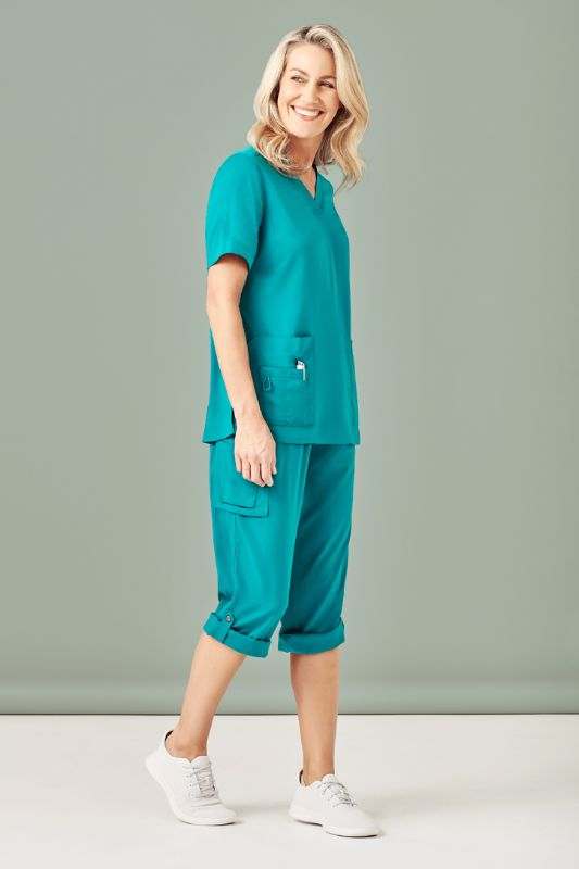 Teal women's scrub pants featuring a straight leg design, multi pockets, and roll-up option, perfect for healthcare professionals.