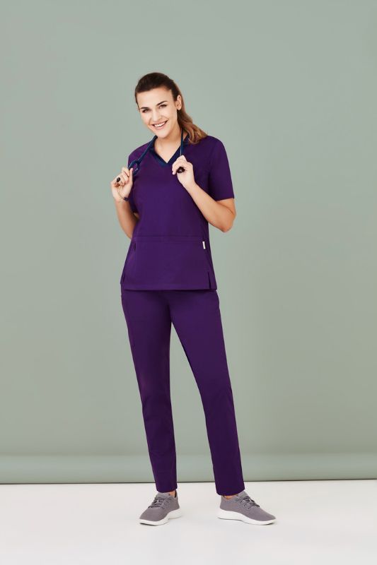 Women's Riley V-Neck Scrub Top in purple, size XXS, featuring breathable fabric and antibacterial stretch side panels for movement.