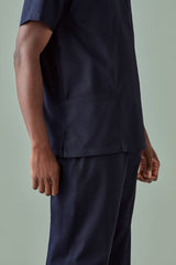 Unisex reversible scrub top in Midnight Navy (XXS) with chest and back pockets, ideal for healthcare professionals.