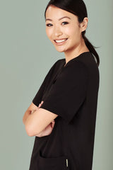 Black women's Avery V-neck scrub top (Size S) with pockets and a wicking finish, designed for comfort and functionality.