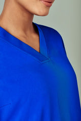 Electric Blue women's V-neck scrub top by Biz Collection, featuring pockets, internal loops, and moisture-wicking fabric for comfort.