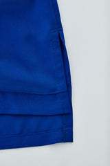 Women's Electric Blue Avery Scrub Top in XXS, features a tailored fit, multiple pockets, and wicking fabric for comfort.