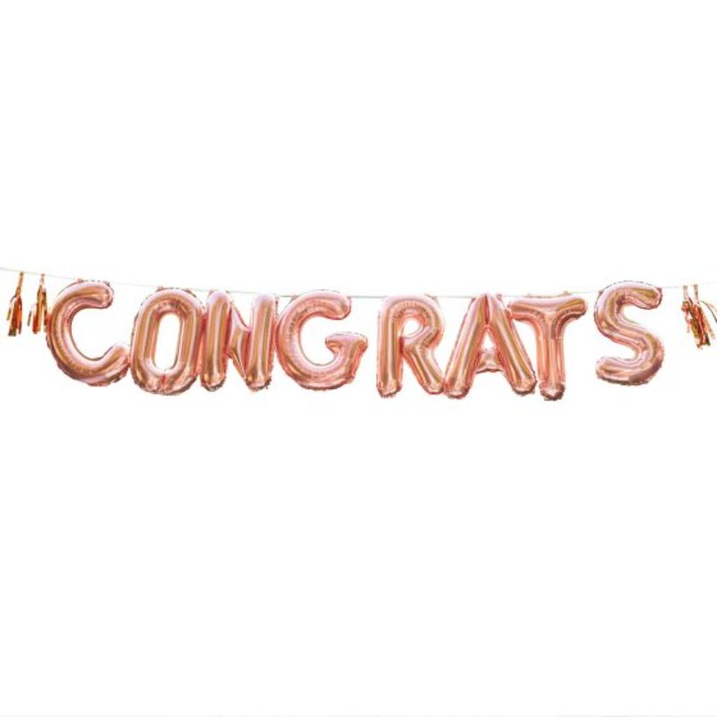 Rose gold balloon bunting spelling 'CONGRATS' with tassels, perfect for celebrations; pack includes 7 balloons, 4 tassels, and twine.