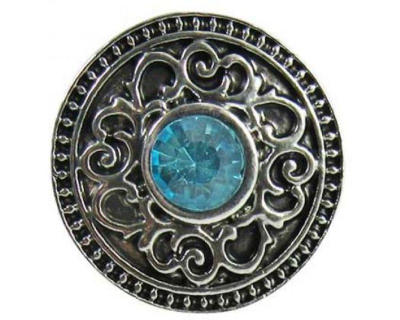 Intricate Celtic snap featuring a sparkling blue crystal, perfect for enhancing your jewelry collection.