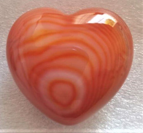 Red Calcite Heart (3cm) displaying vibrant red hues, symbolizing love and vitality, ideal for meditation and decoration.