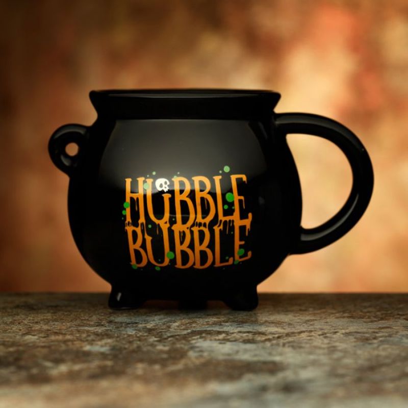 Ceramic cauldron-shaped mug in black, perfect for hot beverages, adds a whimsical touch to any drinkware collection.