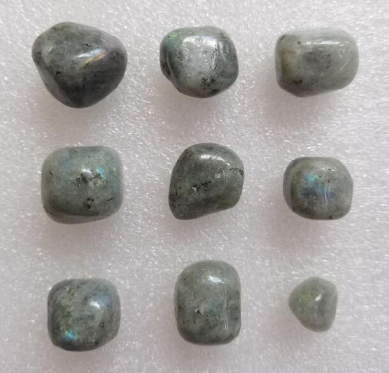 Loose tumbled stones featuring Silver Labradorite and Blood Jasper, ideal for crystal enthusiasts and decorative uses.