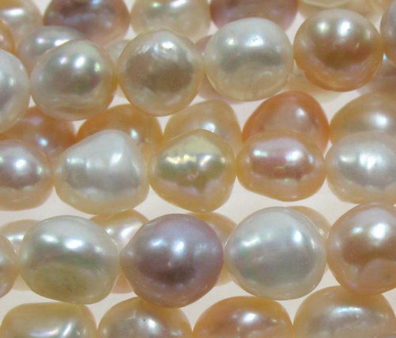 Set of 4 multi-colored pearl beads, 7.6x6mm, 39.5cm strand, perfect for elegant jewelry-making projects.