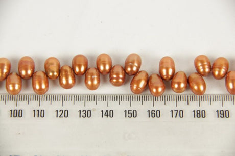 Freshwater pearls in copper hue, showcasing natural luster and artisanal charm for elegant jewelry designs.