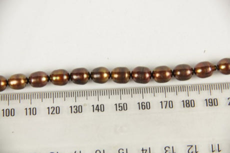 Freshwater pearl beads in brass, featuring unique luster for elegant jewelry designs like necklaces and earrings.