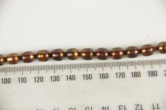 Freshwater pearl beads in brass, featuring unique luster for elegant jewelry designs like necklaces and earrings.