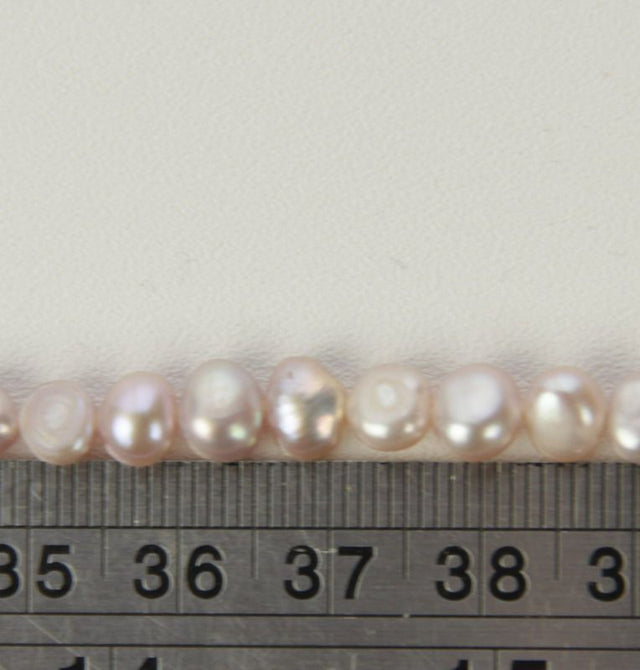 Freshwater pearls in elegant purple, set of 4; ideal for stunning jewelry designs and unique accessories.
