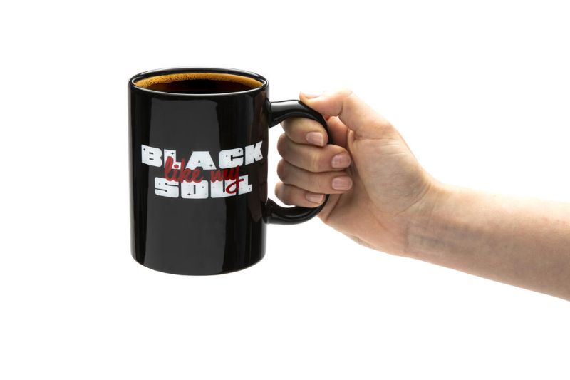 Elegant black ceramic mug with unique design, perfect for coffee and tea lovers, combining style and functionality.