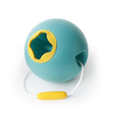 Green Ballo Bucket by Quut, a stable, soft-touch beach toy designed for easy scooping and pouring for imaginative play.