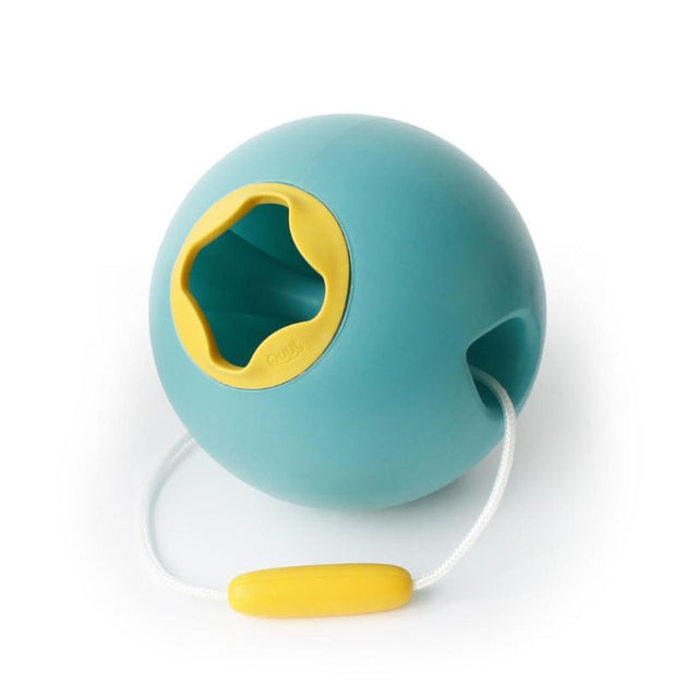 Green Ballo Bucket by Quut, a stable, soft-touch beach toy designed for easy scooping and pouring for imaginative play.