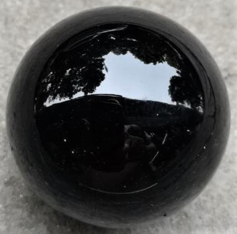 4cm polished Obsidian crystal sphere, ideal for meditation, home decor, and absorbing negative energy.