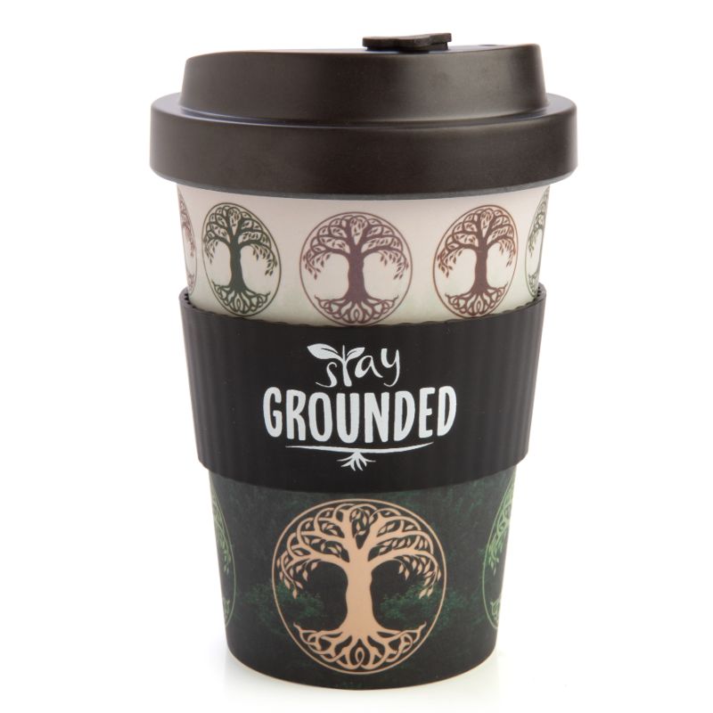 Bamboo travel cup featuring Tree of Life design, anti-spill lid, and silicone band with 'Stay Grounded' phrase. 470ml capacity.