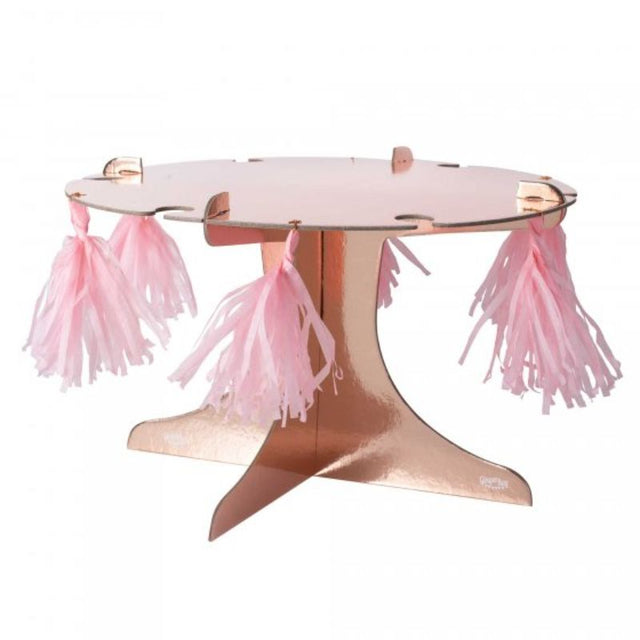 Rose gold treat stand with six pink tassels, perfect for showcasing desserts at any celebration, measuring 36cm wide and 22cm high.