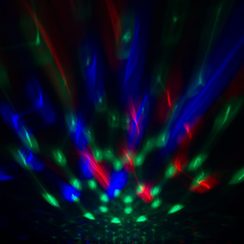 Wireless speaker shaped like a blue disco ball, projecting colorful lights and delivering powerful sound for parties.