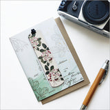 Greeting card featuring Sarah Featon's Puriri floral artwork, accompanied by a bamboo bookmark with botanical details.