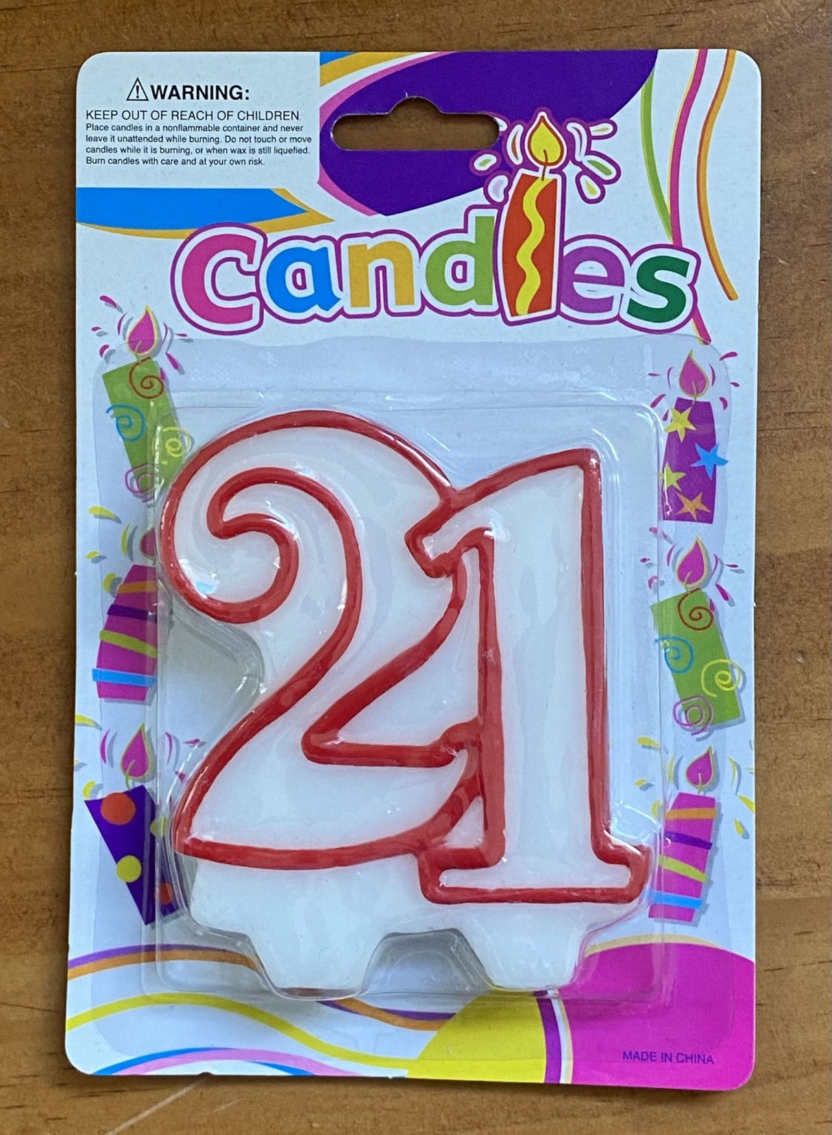 Elegant '21' birthday candle in vibrant colors, perfect for adding sparkle to 21st birthday cakes at a clearance price.