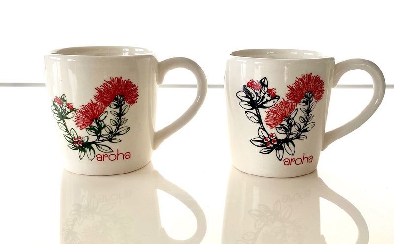 Set of 4 ceramic mugs featuring vibrant Pohutukawa designs, perfect for any beverage and celebrating New Zealand's beauty.