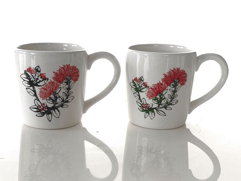 Set of 4 ceramic mugs featuring intricate Pohutukawa designs, perfect for coffee and tea lovers.