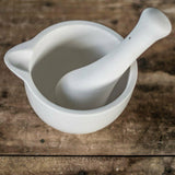 Mason Cash white medium mortar and pestle with unglazed interior for easy grinding of herbs and spices, elegant glazed exterior.