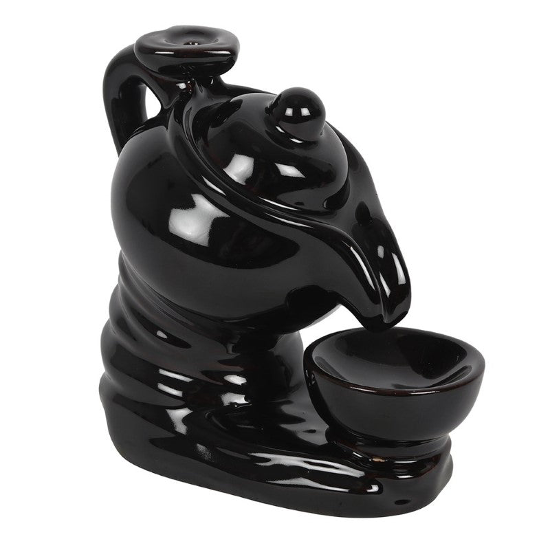 Black ceramic tea pot backflow incense burner, featuring delicate smoke cascading from the spout into the cup for relaxation.