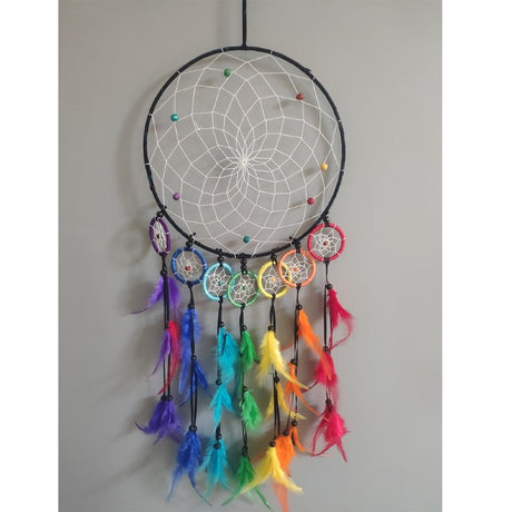 Chakra 8 Hoop Dreamcatcher with vibrant colors, fabric tassels, and wooden beads for positive energy and decor enhancement.