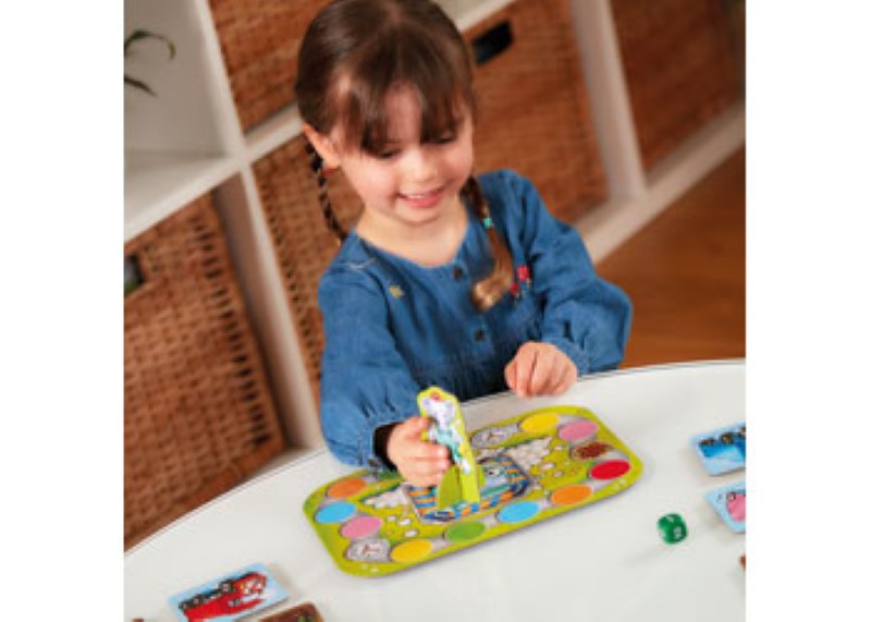 Colorful board game featuring trucks navigating through a muddy farm, promoting learning and teamwork for kids aged 3 and up.