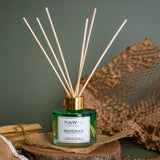 Abundance Sandalwood Reed Diffuser in ombre glass with genuine jade for promoting prosperity and a soothing aroma.