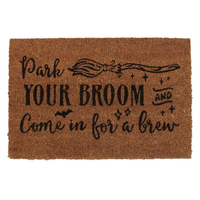 Natural coir doormat with 'Park your broom and come in for a brew' design, perfect for welcoming guests to a witchy home.