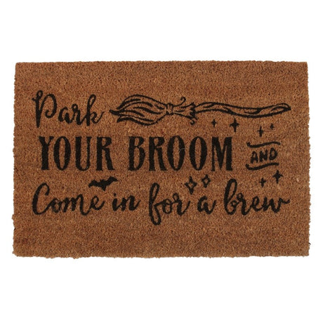 Natural coir doormat with 'Park your broom and come in for a brew' design, perfect for welcoming guests to a witchy home.