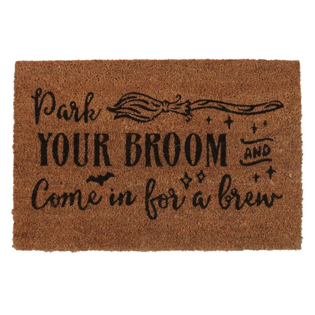 Natural coir doormat with 'Park your broom and come in for a brew' design, perfect for welcoming guests to a witchy home.
