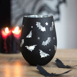 Stemless wine glass with whimsical bat designs and a striking silver interior, perfect for gothic decor and Halloween gatherings.