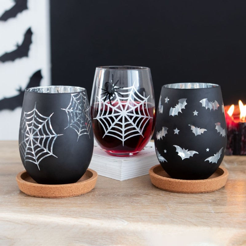 Set of 2 spooky stemless wine glasses featuring a spider design and a silver-accented web silhouette, perfect for Halloween.