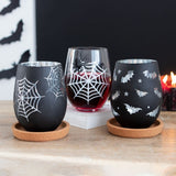 Set of 2 spooky stemless wine glasses featuring a spider design and a silver-accented web silhouette, perfect for Halloween.