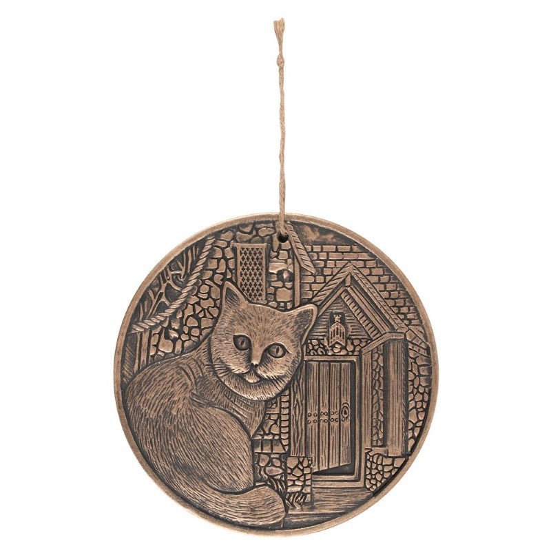 Circular terracotta plaque by Lisa Parker with a copper finish, perfect for adding bohemian charm to any wall.