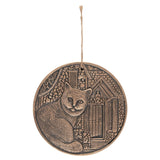 Circular terracotta plaque by Lisa Parker with a copper finish, perfect for adding bohemian charm to any wall.