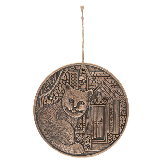 Circular terracotta plaque by Lisa Parker with a copper finish, perfect for adding bohemian charm to any wall.