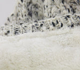 Cream textured beanie with fleece lining, fur pom pom, and cozy 100% acrylic fabric for winter warmth and style.