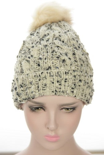 Cream textured beanie with fleece lining, fur pom pom, stylish and warm for winter outings. Perfect for cozy looks.